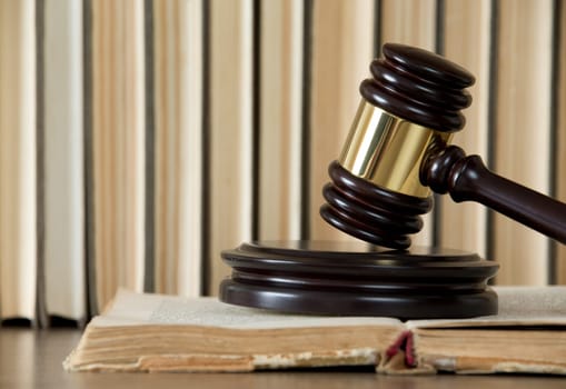 wooden gavel and books on wooden table