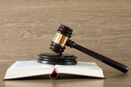 wooden gavel and books on wooden table