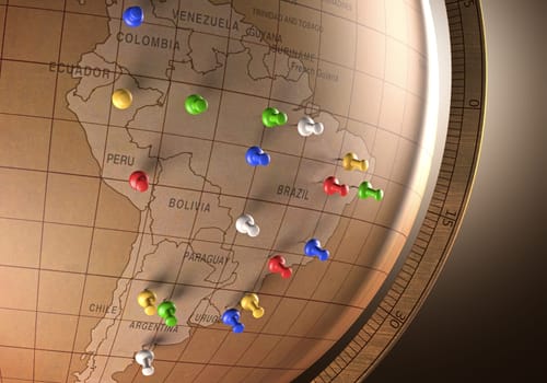 Antique globe with nails marking the travel route.