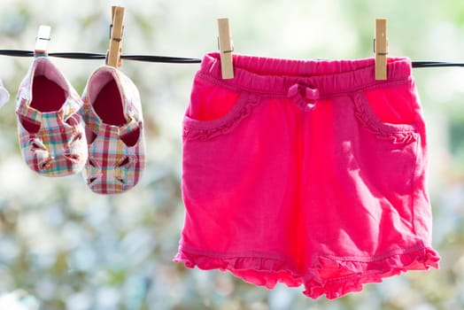 Old photo of baby clothes hanging on the clothesline