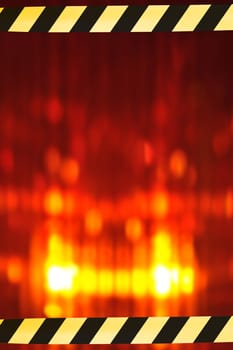 Construction site background with macro detail of an orange all-round light and two original shut-off strips
