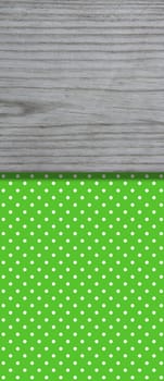 Green dotted background with grey wooden board