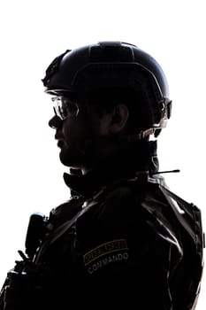 Silhouette of young soldier in military helmet on white background