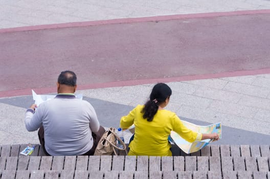 two unknown tourists reading a map in Miniaturk park in istanbul, the largest miniature park in the world. The park contains 105 buildings, each replicated on a scale of 1