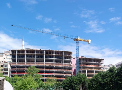 high-rise building with a crane on a construction site