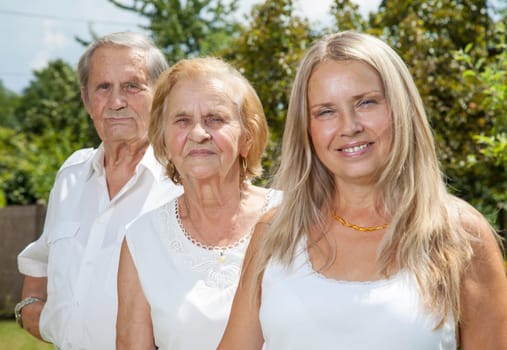 Elderly couple and their daughter outdoors