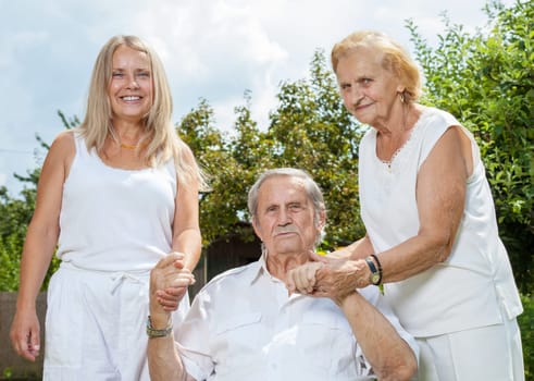 Elderly couple and their daughter outdoors