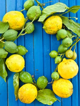Fresh organic lemons on background made of blue wood
