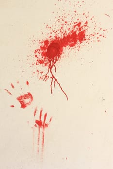 Color smudders and imprints of hands with red color on a bright wall