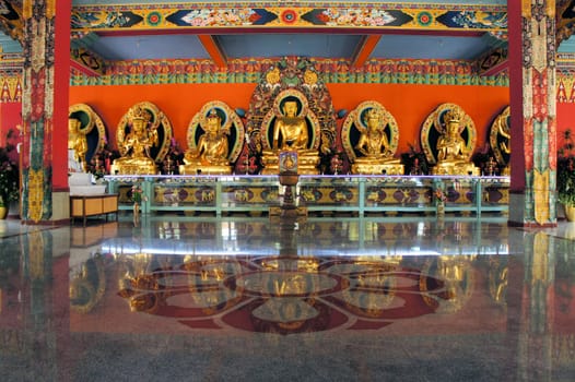 Statues of Guru Rinpoche, Lord Buddha and Buddha Amitayus in the monastery of the largest Tibetan refugee camp in Bylakuppe, Karnataka, India