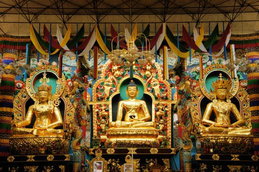 Statues of Guru Rinpoche, Lord Buddha and Buddha Amitayus in the monastery of the largest Tibetan refugee camp in Bylakuppe, Karnataka, India