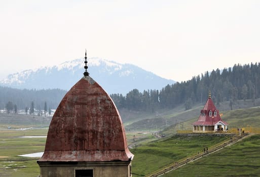 An Islamic mosque in front of a Hindu temple in Gulmarg, Jammu and Kashmir, India