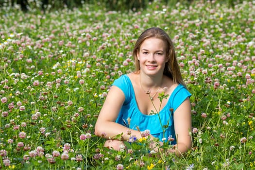 little girl on the meadow in summer day
