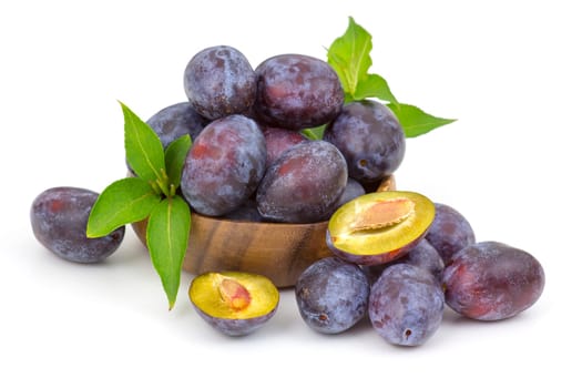 fresh plums in a bowl on white background