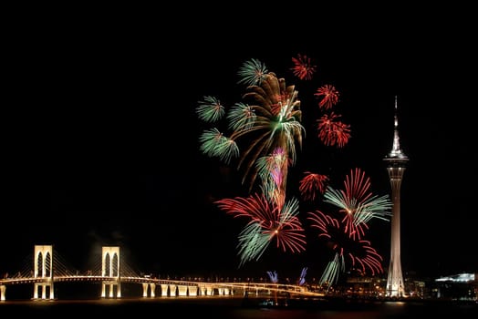 Celebration of New Year in Macau with fireworks beside the Tower Convention and Sai Van bridge
