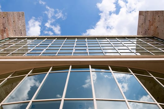 Blue office building with reflections of skyscraper