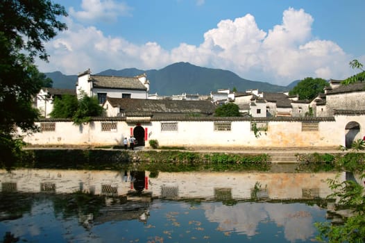 The facade of Hongcun village with reflection, in China