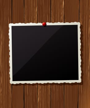 Vintage photo frame pinned on the wooden wall