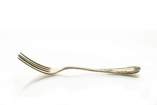 Fork with decoration and reflection on white background