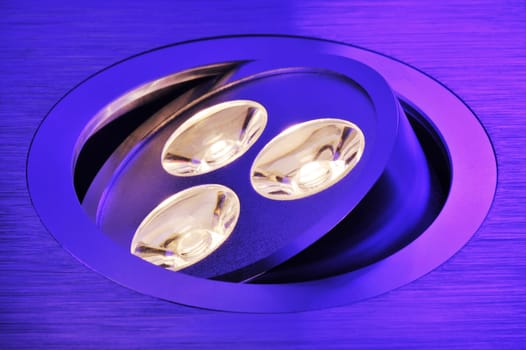Macrodetail of a warm white triple LED in violet light