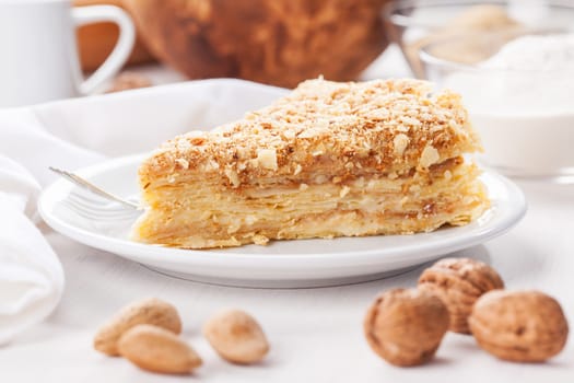 Traditional Russian pancakes pie with nuts and baking ingredients
