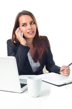Pretty business woman on the phone, working in front a laptop, isolated on white