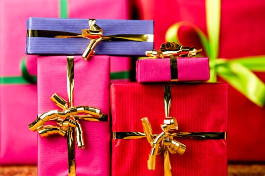 Presents packed in plain colors with bows. Tightly cropped, flattened space. Background for any gift exchange..