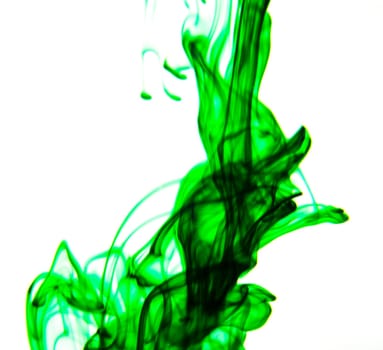 Vegetable ink poured into water with white background.