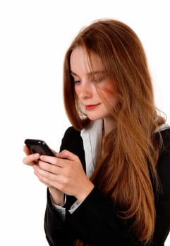 A young business woman texting on her cell phone, with long brunette.hair, isolated for white background..