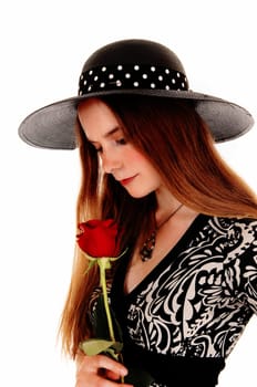 A portrait picture of a pretty woman holding a red rose and wearing a.nice hat, isolated for white background..