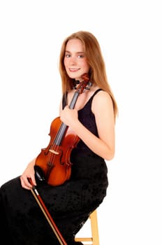 A pretty woman in a black dress sitting and holding her violin, smiling.into the camera, isolated for white background..