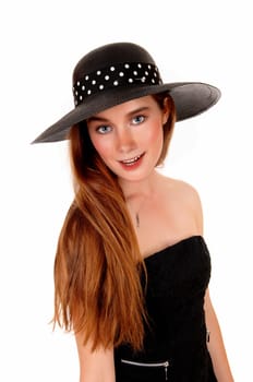 A lovely young woman with long brunette hair and a black hat standing.isolated for white background..
