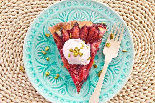 Cake with fresh plums with a scoop of ice cream