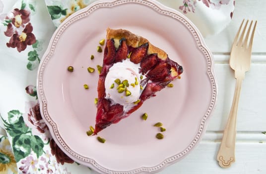 Cake with fresh plums with a scoop of ice cream