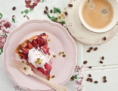 Cake with fresh plums with a scoop of ice cream and a cup of coffee