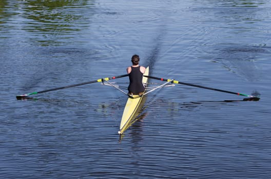 young lady rowing in a canoe