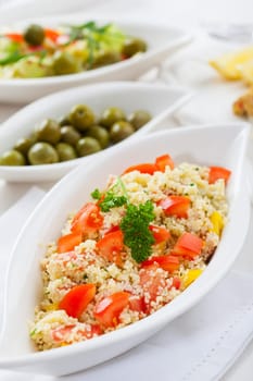 Couscous salad with tomato, pepper with olives