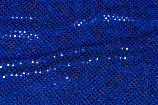 A piece of blue sequined fabric typically used to make dancer's costumes fills the image.
