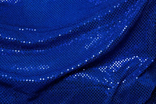 A piece of blue sequined fabric typically used to make dancer's costumes fills the image.
