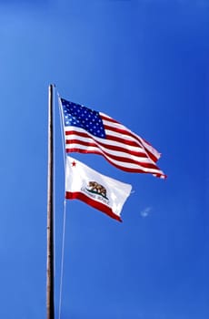 USA and California flags with blue sky