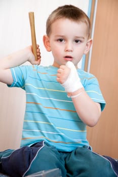 wounded in the left hand with bandage boy at shot in home