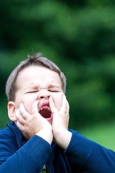 boy outdoors without upper two teeth with pain in the face
