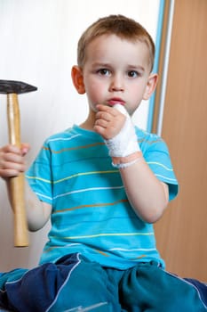 wounded in the left hand with bandage boy at shot in home