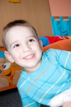 detail of happy face boy at home