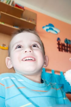 detail of smiling face boy at home