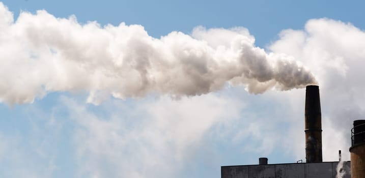 White smoke billows out of industrial stack day in and day out