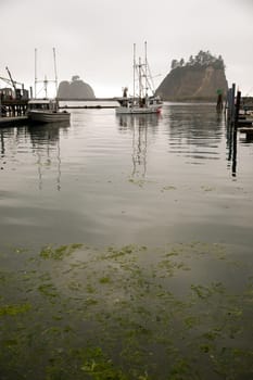 A fishing vessel pulls out after fueling up at the Marina in LaPush