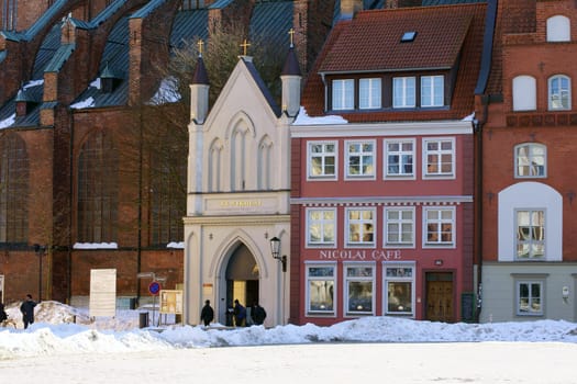 Stralsund,Germany – April 02,2013: The main entrance of the St. Nikolai Church with the adjacent Nikolai Cafe on April 2,2013 in Stralsund.