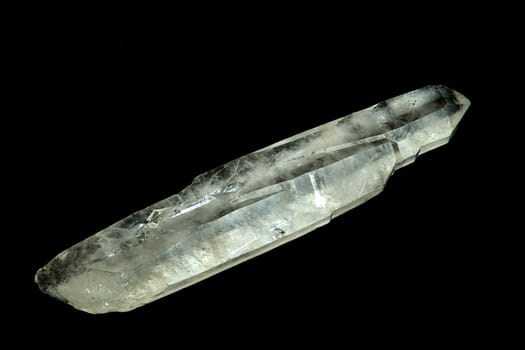 A quartz crystal wand shot over black.