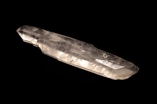 A quartz crystal wand shot over black.